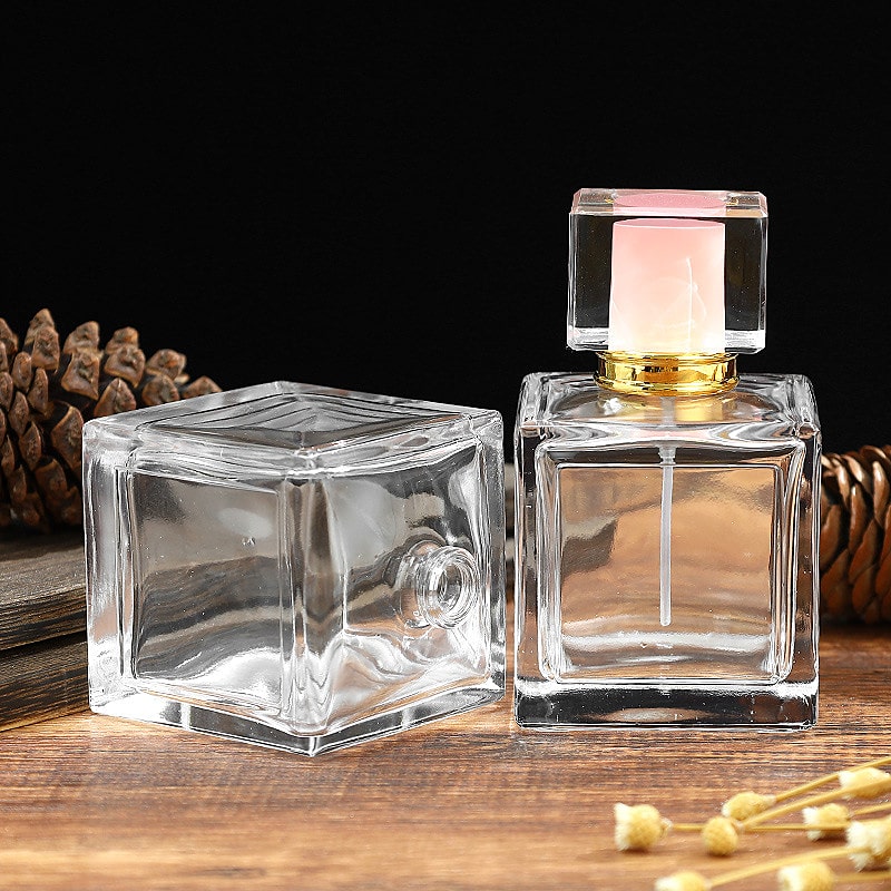 Botella de perfume de vidrio transparente cuadrada de 100 ml
